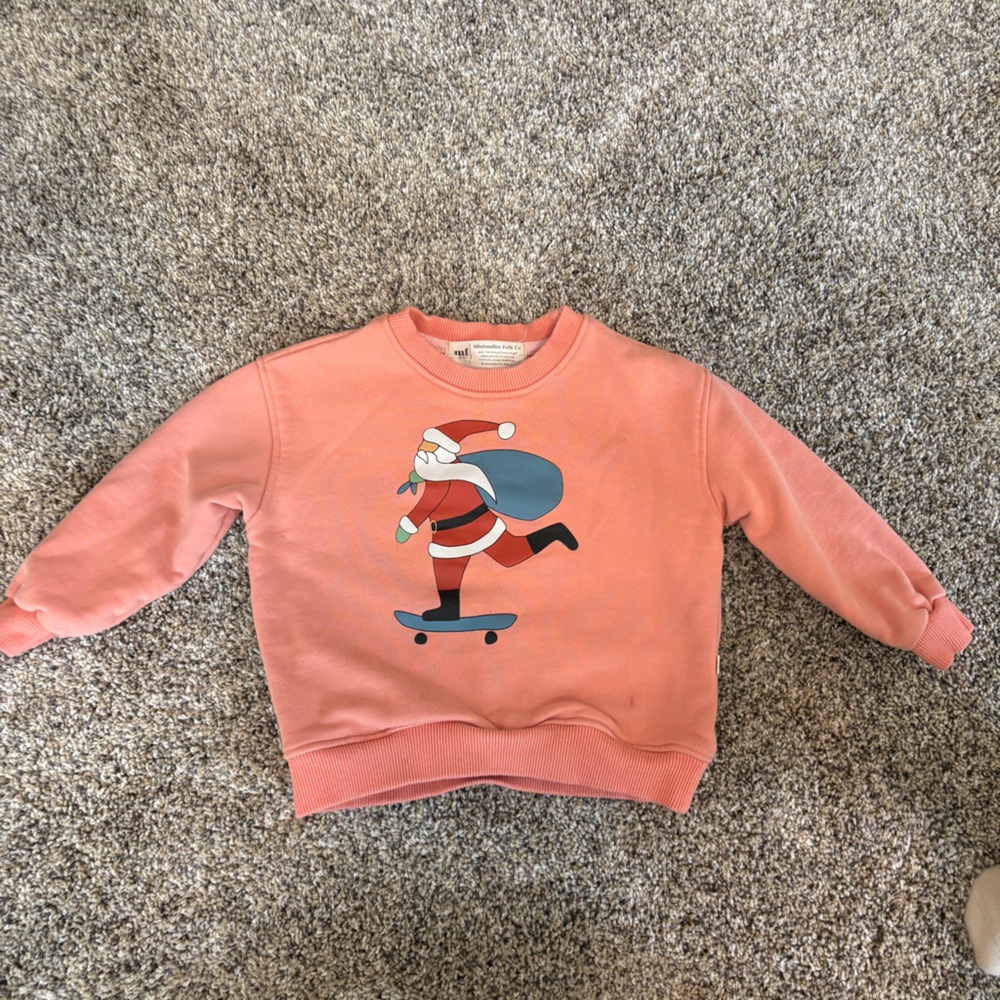 Minimalist Folk Co: Santa Claus Skateboarding Peach colored Sweatshirt